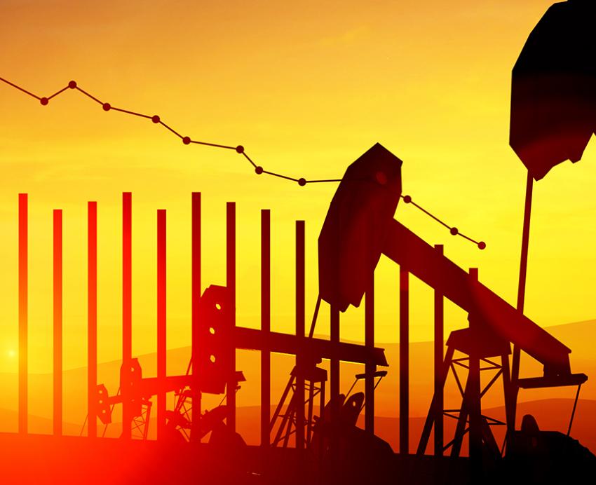 Oil rigs next to a declining graph graphic