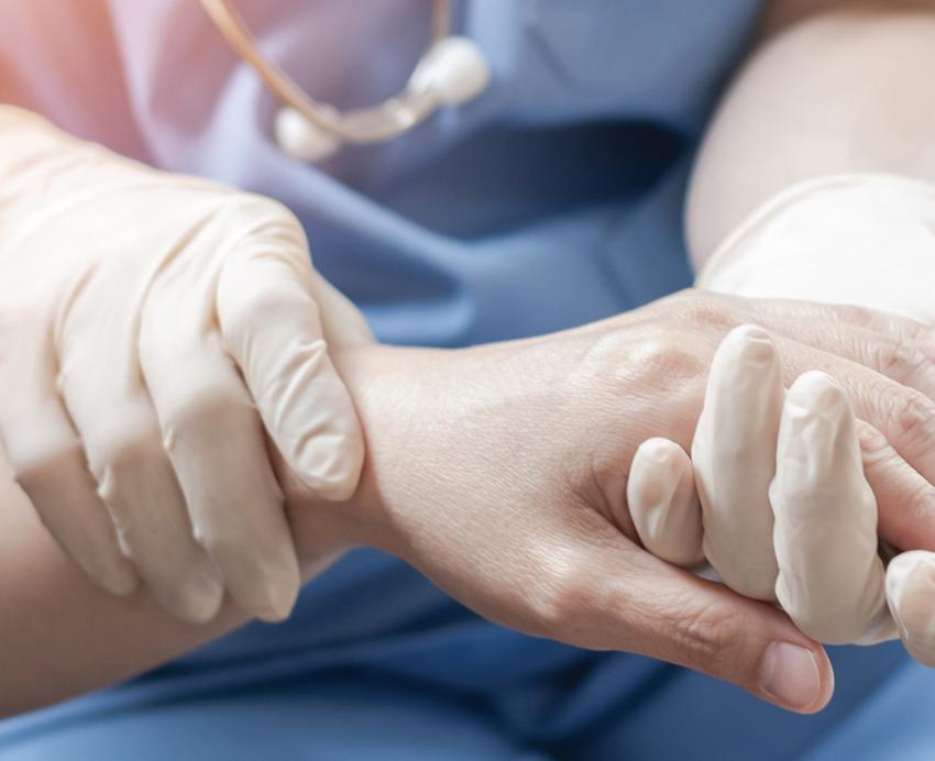Nurse holding the hand of a patient