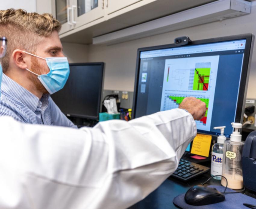 Alexander Sundermann and Lee Harrison working in lab