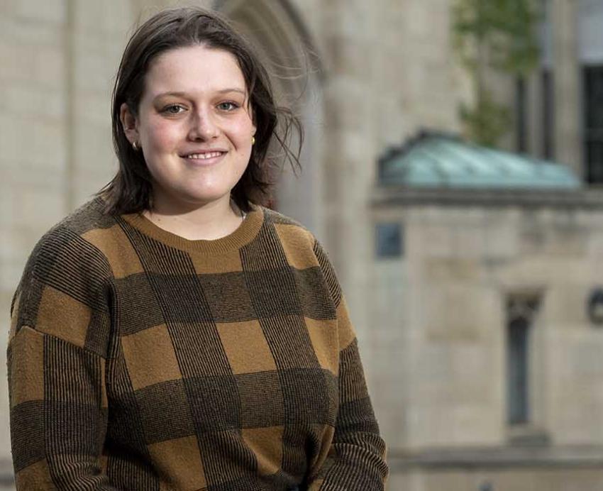 Maja Lynn wearing brown plaid sweater on Pitt campus