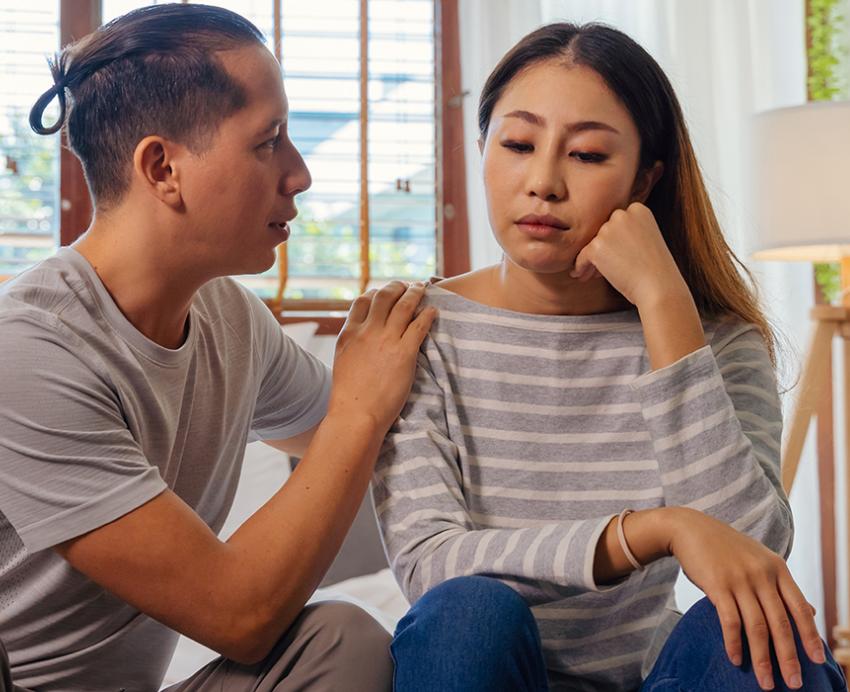 Man comforting a woman during a difficult conversation