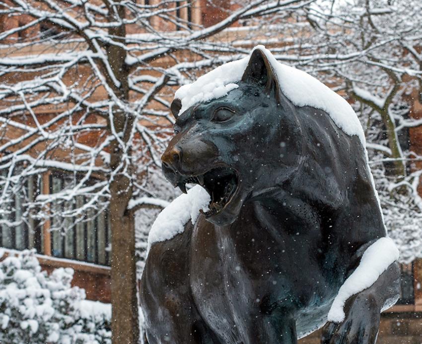 Snow covered panther statue on campus