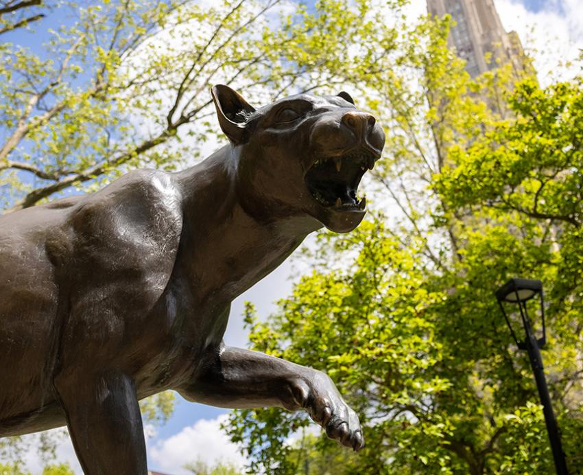 Panther statue in front of the Cathedral of Learning on a sunny day
