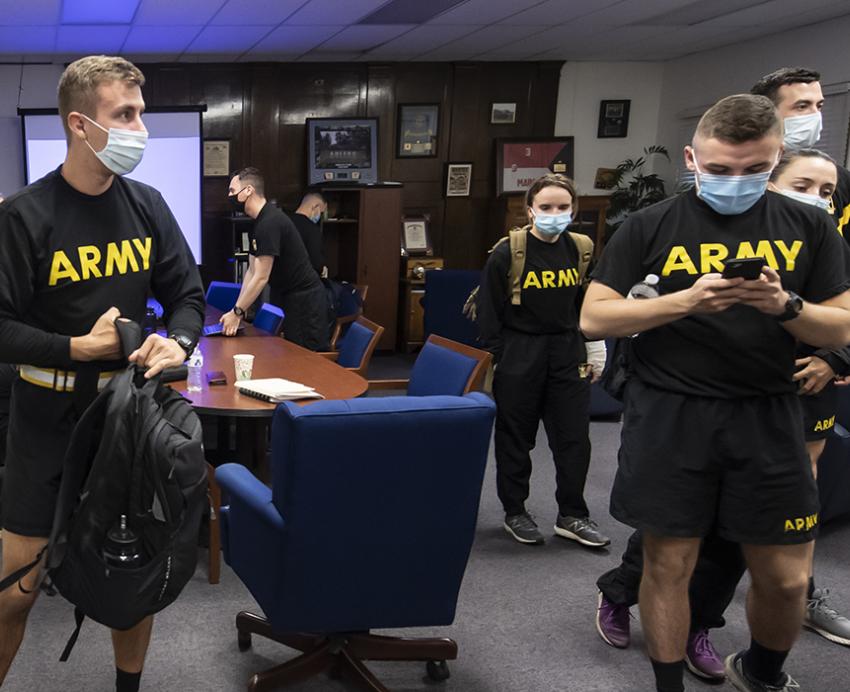 Matthew Starinsky and team wearing black Army shirts and face masks indoors