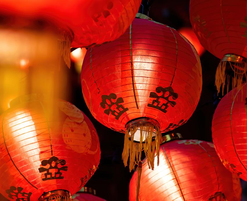 Multiple red lanterns lit up in the dark to celebrate the Lunar New Year.