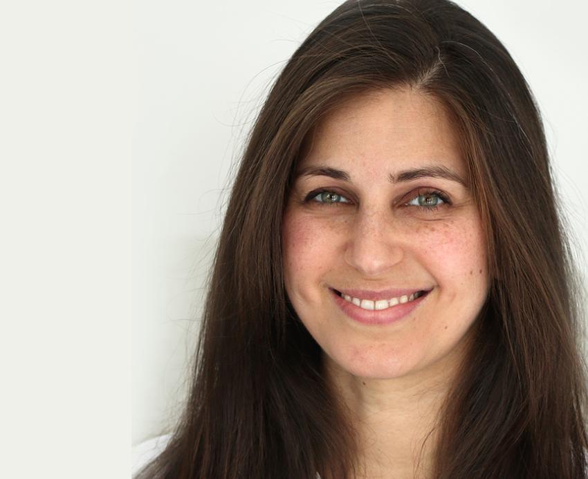 Karina Schumann smiling in front of white background