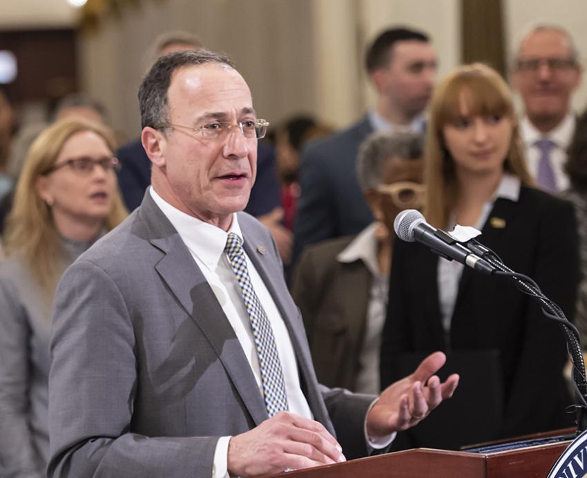 Paul Supowitz speaking at a podium 