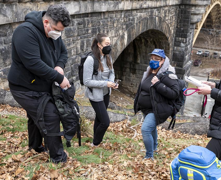 Street Medicine workers helping the homeless near a bridge