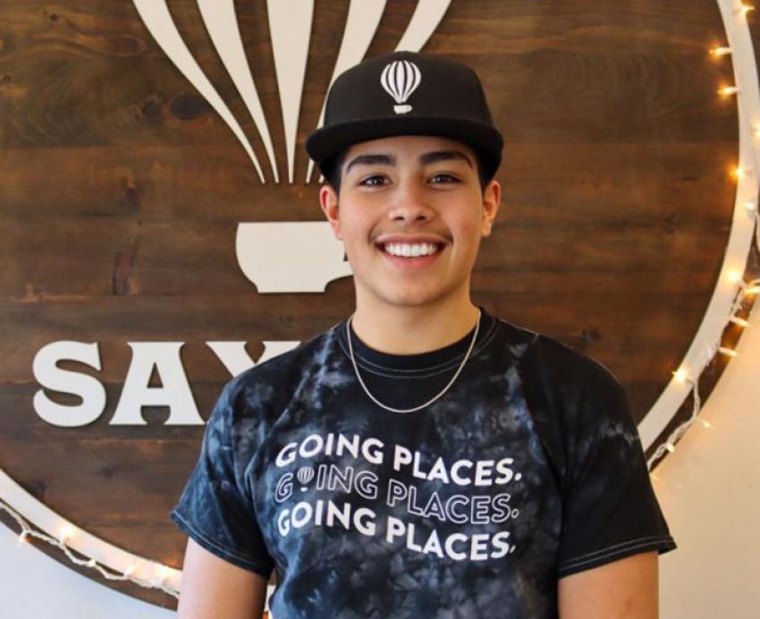 Nishanth Abdullah wearing Saxbys hat and T-shirt