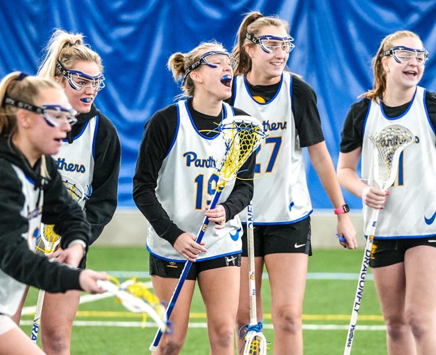 Pitt lacrosse team wearing gear on field 
