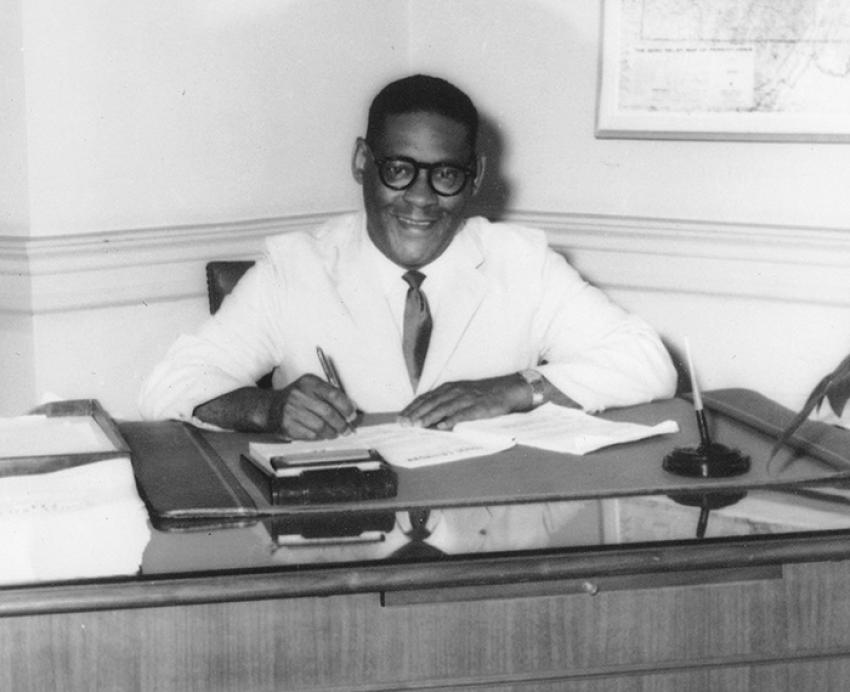 Irvis sitting at his desk