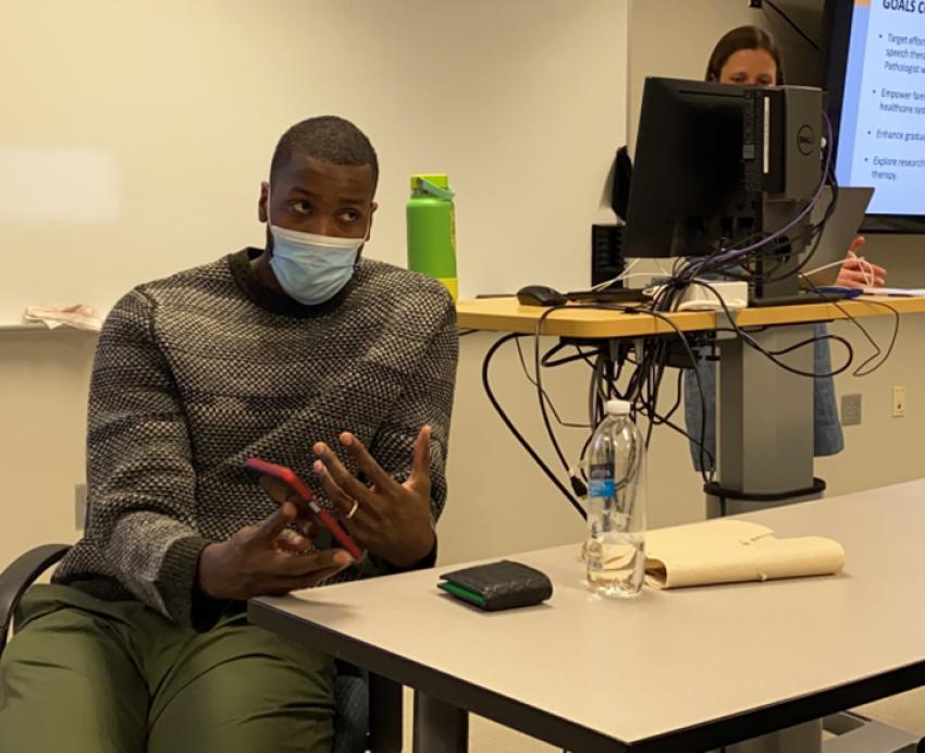 Michael Kidd-Gilchrist sitting at table and speaking in class 