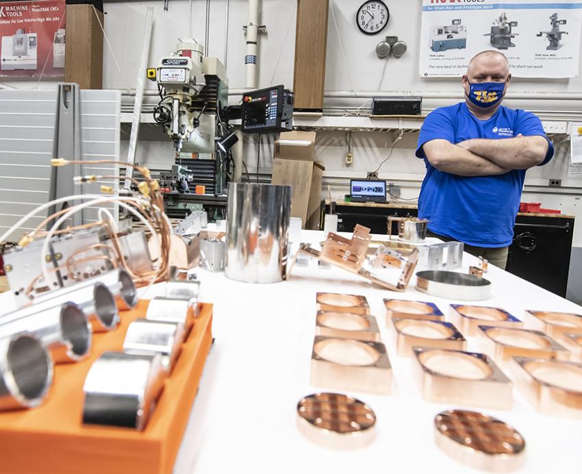 Man wearing Pitt mask standing in machine shop
