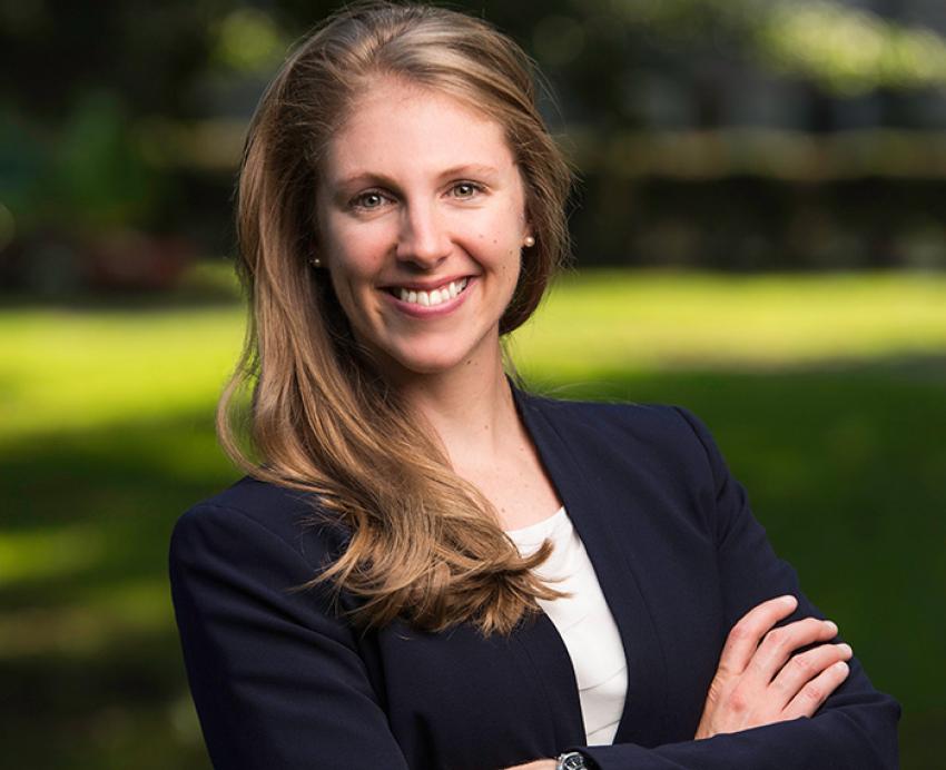 Rebecca Reed smiling outside with black jacket and white shirt