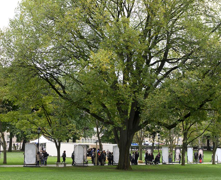 People walking through "Lest we Forget" exhibit