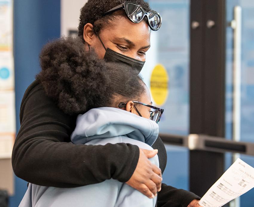 a parent hugging a child