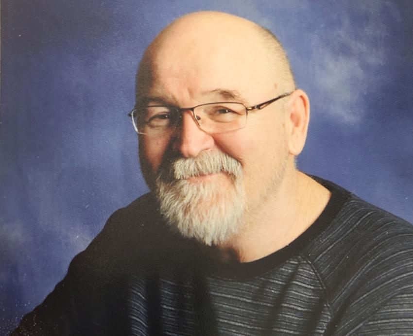 Dorsey Wheeler smiling in front of blue background