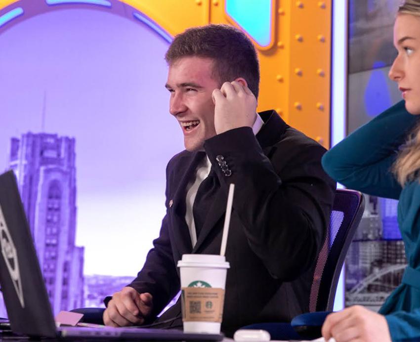 two hosts at a desk in Pitt Studios