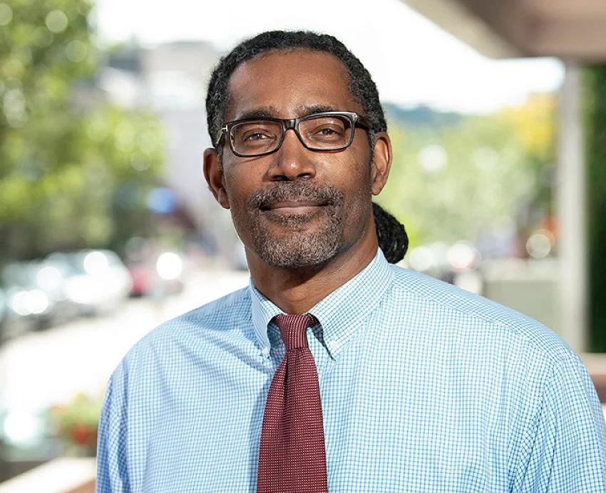 Ervin Dyer outdoors in a light blue dress shirt and red tie