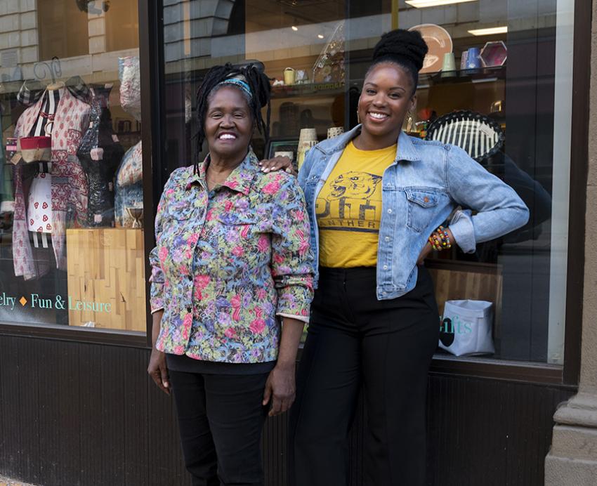 Christine and Brigette Bethea standing in front of store windows