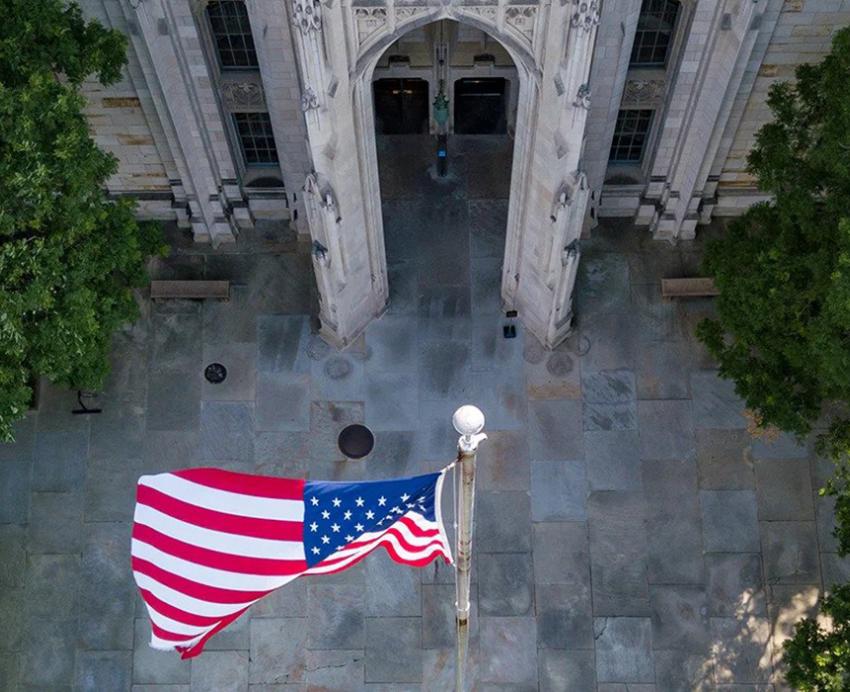 Trees surrounding an American flag shown from above 