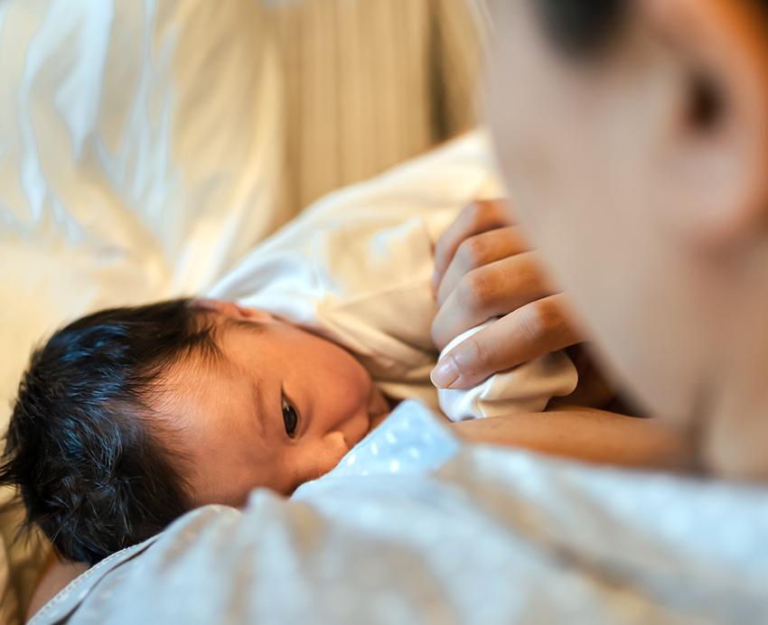 Mother holding baby in blanket