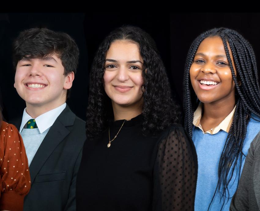 Five Stamps Scholars smiling in front of black background