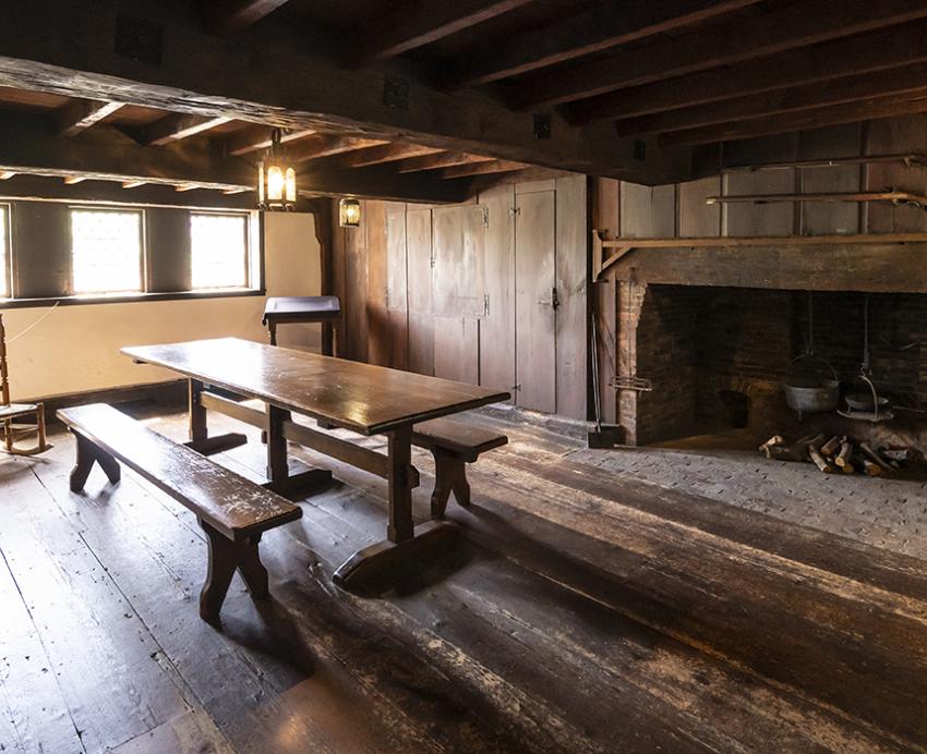 early american room with a large fireplace and table