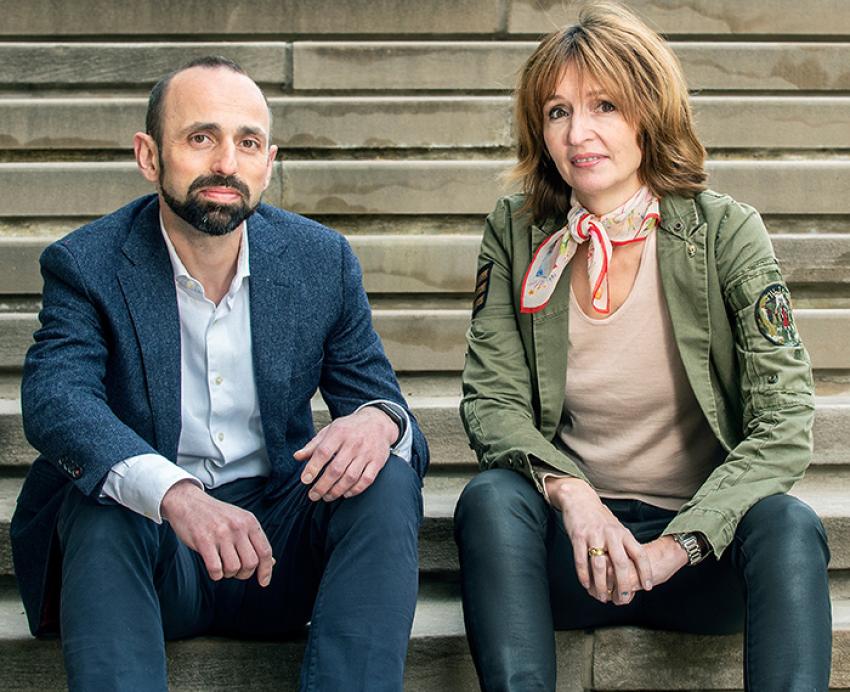 two people sitting on stairs