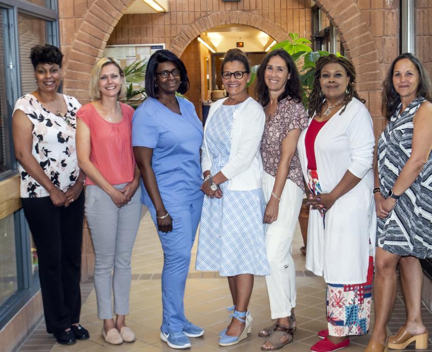 seven women posing together
