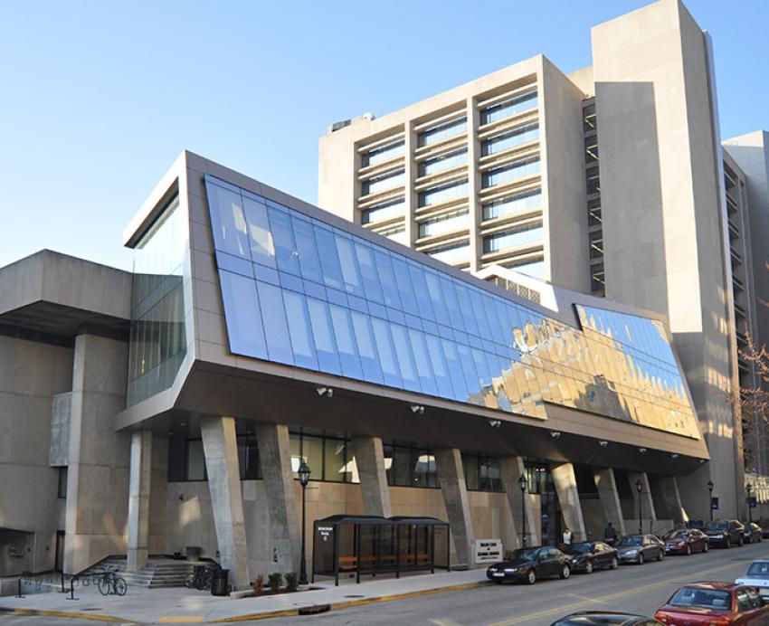 a building with large windows reflecting blue sky