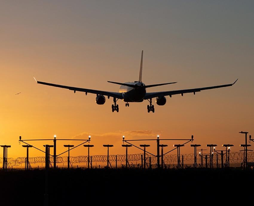an airplane flying at dusk
