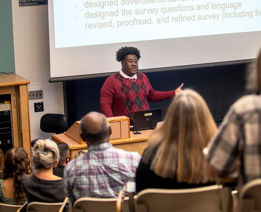 a student presenting to a group of people