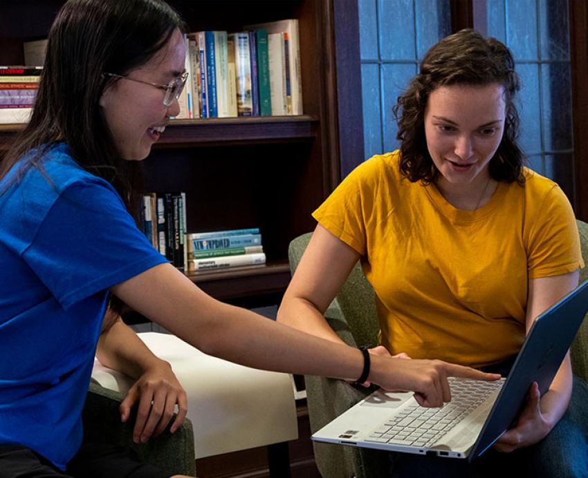 two students at a laptop