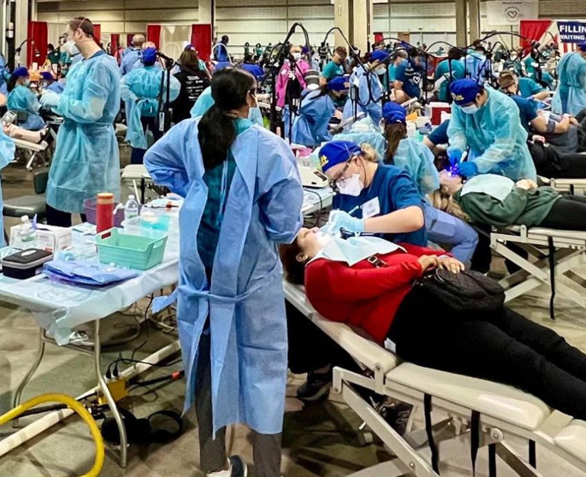 a large room with patients receiving dental care