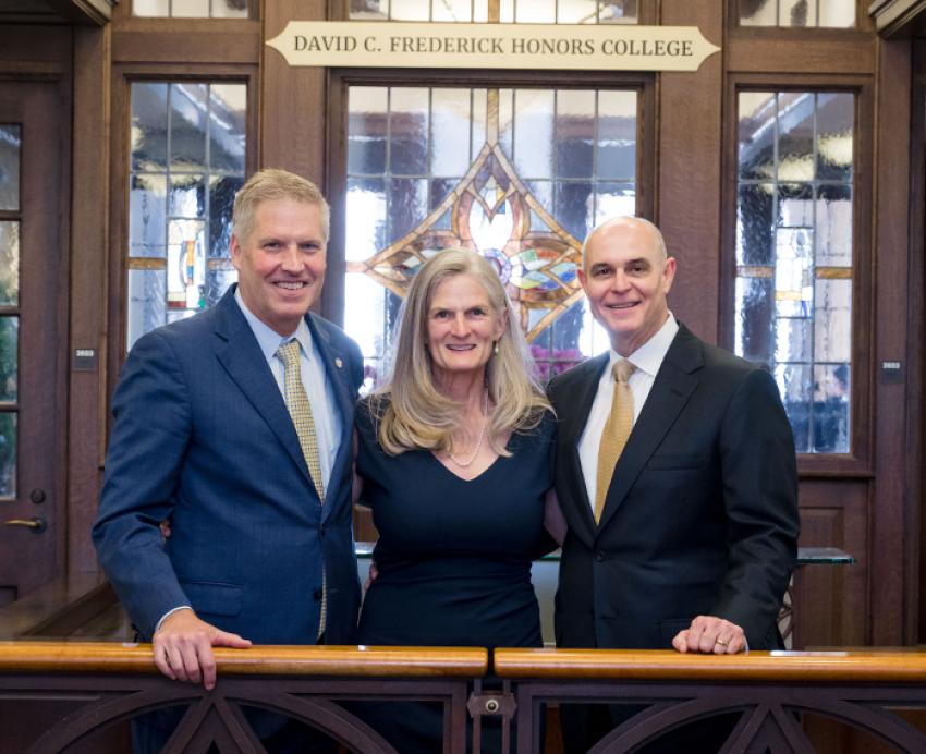 Chancellor Gallagher, Sophie Lynn and David Frederick in front of the new college sign