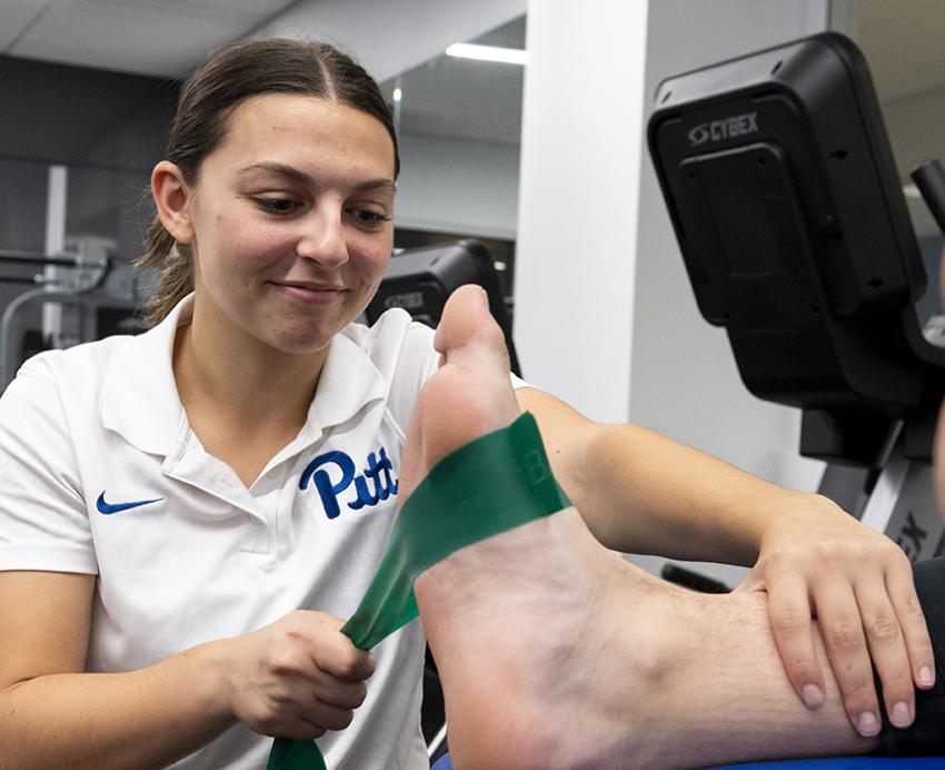 Jessica Muney treats a Pitt football player