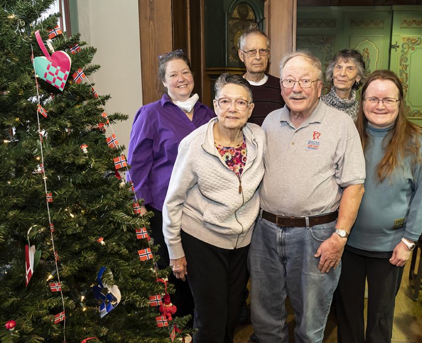 a family standing next to a Christmas tree