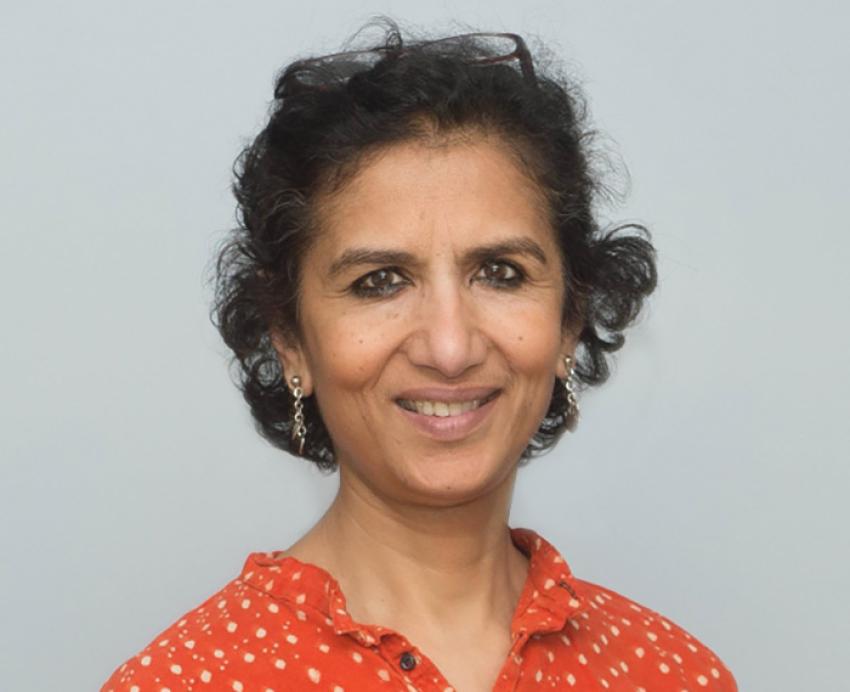 A headshot of Singh