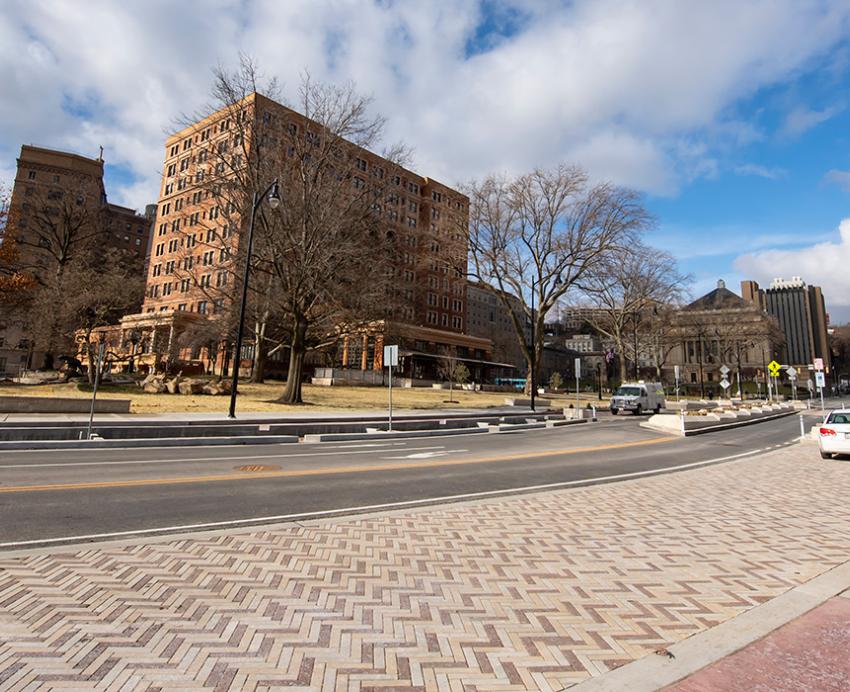 A road with traffic medians, bike lands and sidewalks