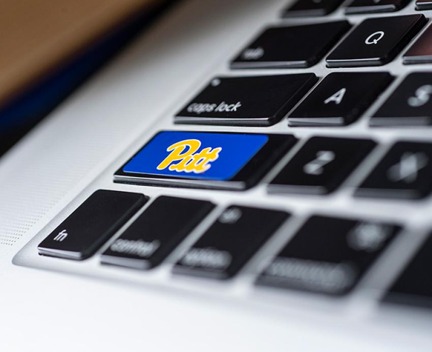 A Pitt script sticker on the Enter key of a keyboard