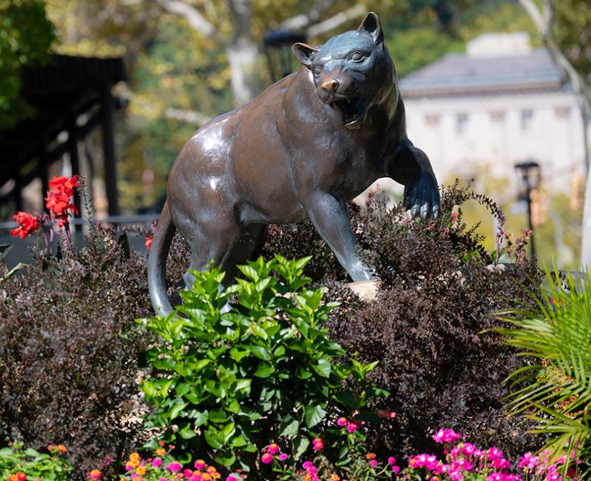 A panther statue surrounded by plants