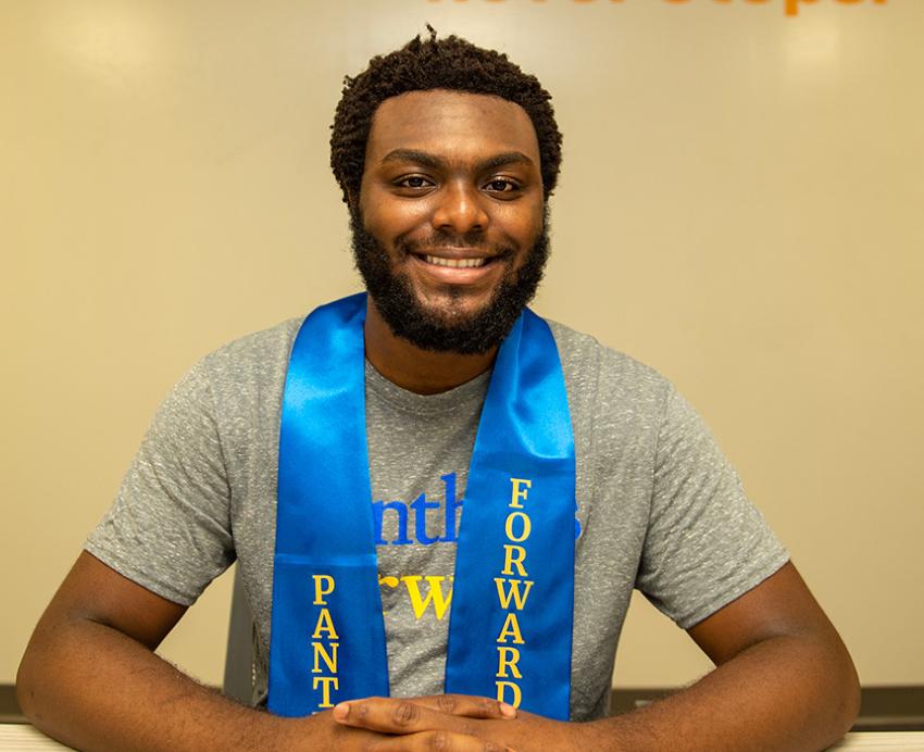 Wah wears a blue Panthers Forward stole