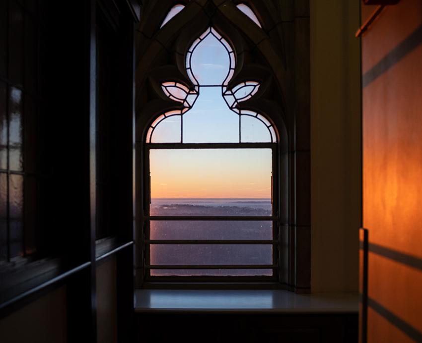 The sunsets through a window