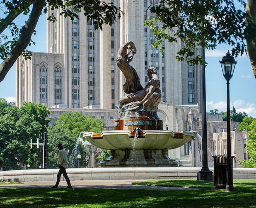 A person walks by a fountain