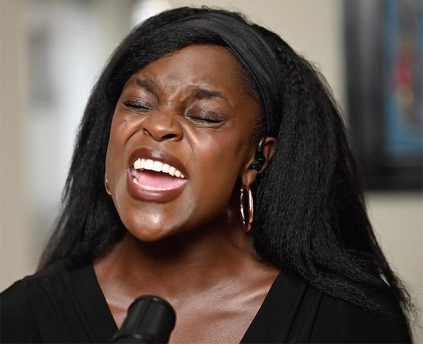 A woman in black sings