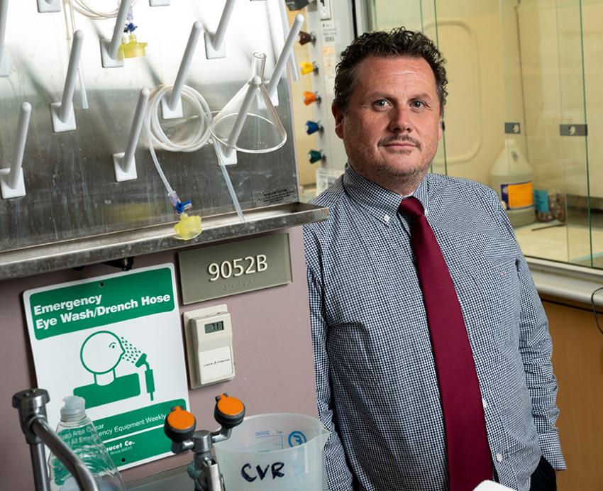 Duprex stands in his lab