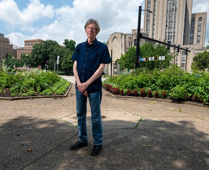 Savage stands in a courtyard near the Cathedral of Learning