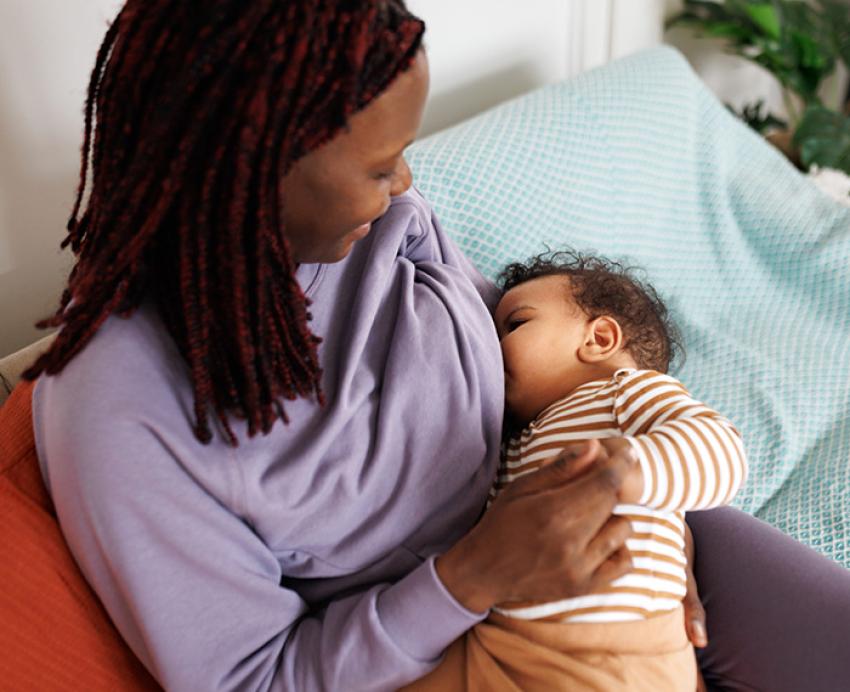 A person breastfeeds an infant