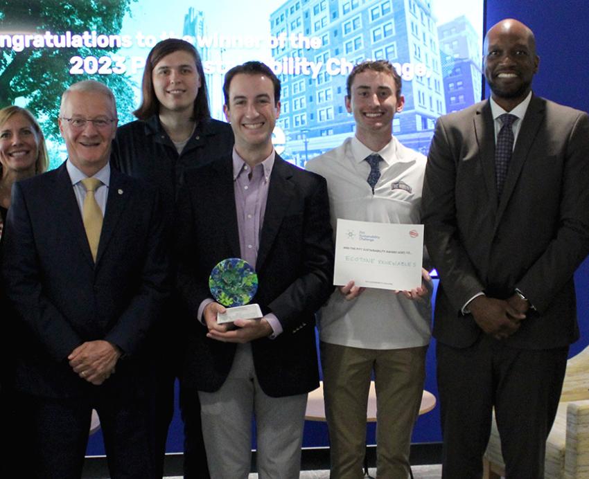 The ecotone renewables team poses around their statue and certificate